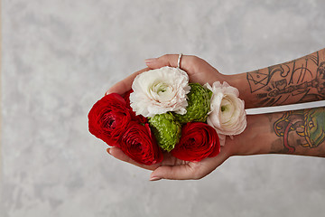 Image showing girl with a tattoo on her hands holding a bouquet of flowers