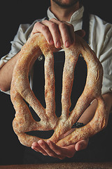 Image showing Baker holding fougas bread