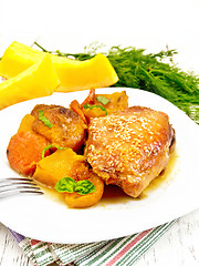 Image showing Chicken roast with pumpkin and dried apricots on table