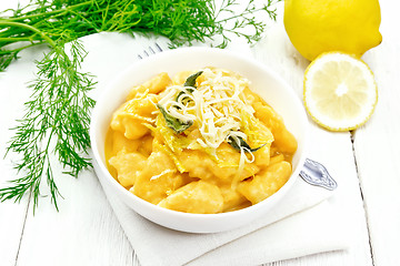 Image showing Gnocchi pumpkin with lemon in bowl on wooden board