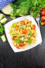 Image showing Fusilli with chicken and tomatoes in plate on board top