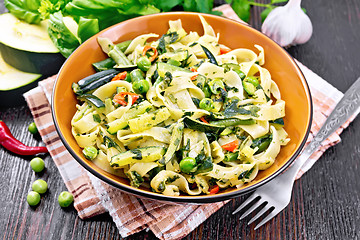 Image showing Tagliatelle with green vegetables on wooden board