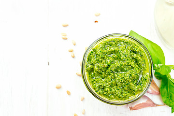 Image showing Pesto in jar on board top