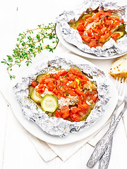 Image showing Salmon with vegetables in plate on wooden board