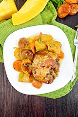 Image showing Chicken roast with pumpkin and dried apricots on dark board top