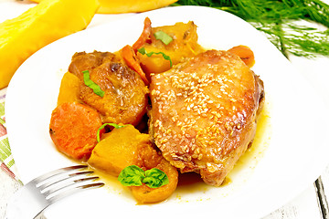 Image showing Chicken roast with pumpkin and dried apricots on light board