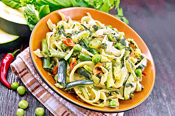 Image showing Tagliatelle with green vegetables on board