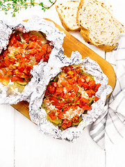 Image showing Salmon with vegetables in foil on light board top