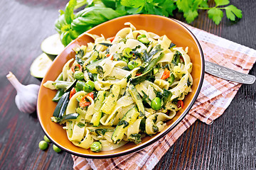 Image showing Tagliatelle with green vegetables on dark board