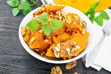 Image showing Pumpkin with nuts and honey on table