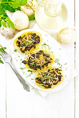 Image showing Potatoes stuffed with mushrooms on light board top