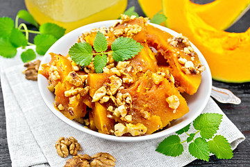 Image showing Pumpkin with nuts and honey on board