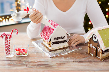 Image showing woman making gingerbread house on christmas