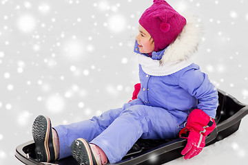 Image showing happy little girl on sled outdoors in winter