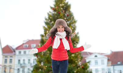 Image showing happy woman over christmas tree in tallinn