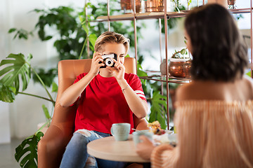 Image showing women drinking coffee and photographing at cafe