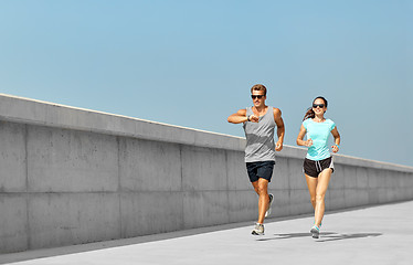 Image showing couple in sports clothes running outdoors