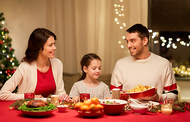 Image showing happy family having christmas dinner at home