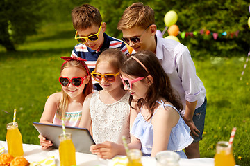 Image showing happy kids with tablet pc on birthday party