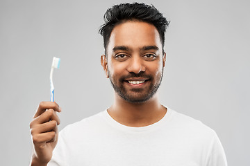 Image showing indian man with toothbrush over gray background