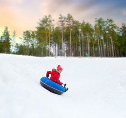 Image showing happy teenage girl sliding down hill on snow tube