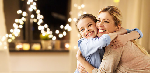 Image showing happy smiling family hugging at home on christmas