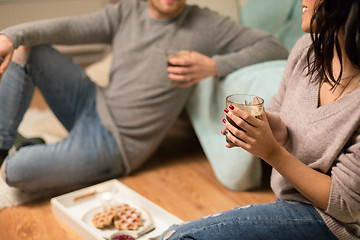 Image showing close up of couple drinking coffee at home