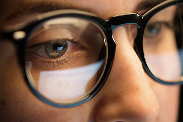 Image showing close up of woman in glasses looking at screen