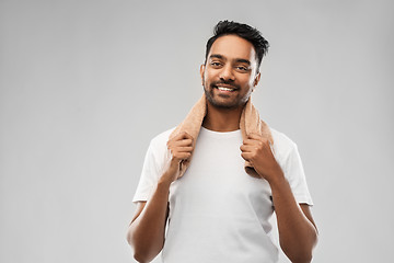 Image showing smiling indian man with towel over grey background