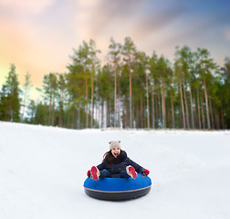 Image showing happy teenage girl sliding down hill on snow tube