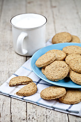 Image showing Fresh baked oat cookies on blue ceramic plate on linen napkin an