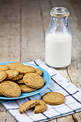 Image showing Fresh baked oat cookies on blue ceramic plate on linen napkin an