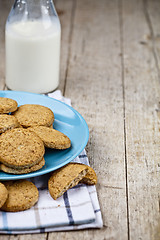 Image showing Fresh baked oat cookies on blue ceramic plate on linen napkin an