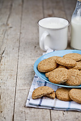 Image showing Fresh baked oat cookies on blue ceramic plate on linen napkin an