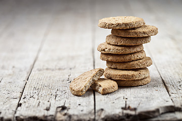 Image showing Stack of fresh baked oat cookies on rustic wooden table backgrou