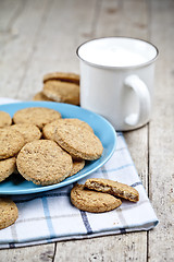 Image showing Fresh baked oat cookies on blue ceramic plate on linen napkin an