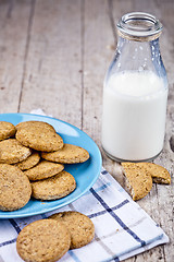 Image showing Fresh baked oat cookies on blue ceramic plate on linen napkin an