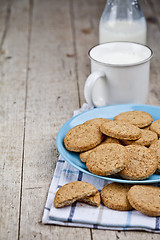 Image showing Fresh baked oat cookies on blue ceramic plate on linen napkin an