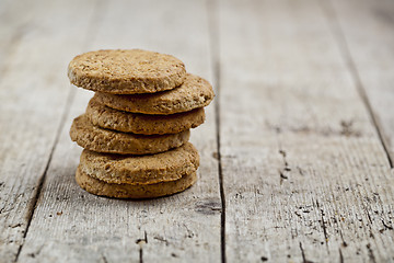 Image showing Stack of fresh baked oat cookies on rustic wooden table backgrou