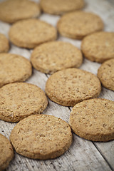 Image showing Fresh baked oat cookies closeup on rustic wooden table backgroun