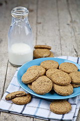 Image showing Fresh baked oat cookies on blue ceramic plate on linen napkin an