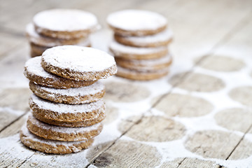 Image showing Fresh baked oat cookies with sugar powder on rustic wooden table
