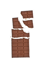 Image showing Broken milk chocolate bar wit hazelnuts.