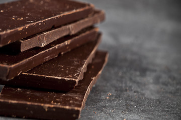 Image showing Dark chocolate bar pieces closeup. Sweet food photo concept. 