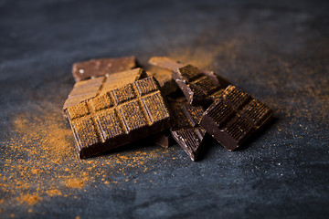 Image showing Chocolate bar pieces heap witn cinnamon powder.