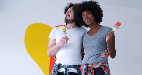 Image showing couple with painted heart on wall