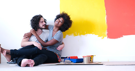 Image showing young multiethnic couple relaxing after painting