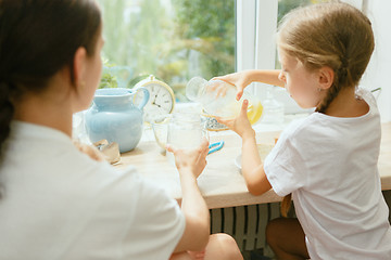 Image showing The happy smiling caucasian family in the kitchen preparing breakfast