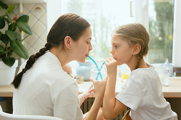 Image showing The happy smiling caucasian family in the kitchen preparing breakfast