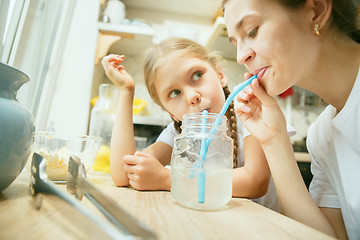 Image showing The happy smiling caucasian family in the kitchen preparing breakfast